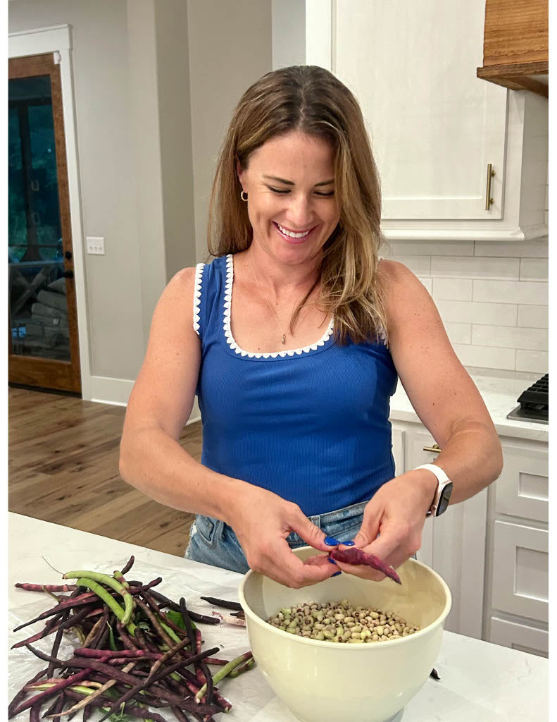 Woman in a kitchen preparing food with a bowl and vegetables.