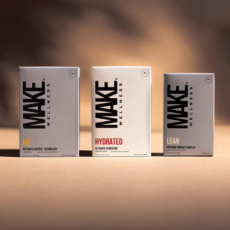 Three 'MAKE Wellness' product boxes on a blurred background